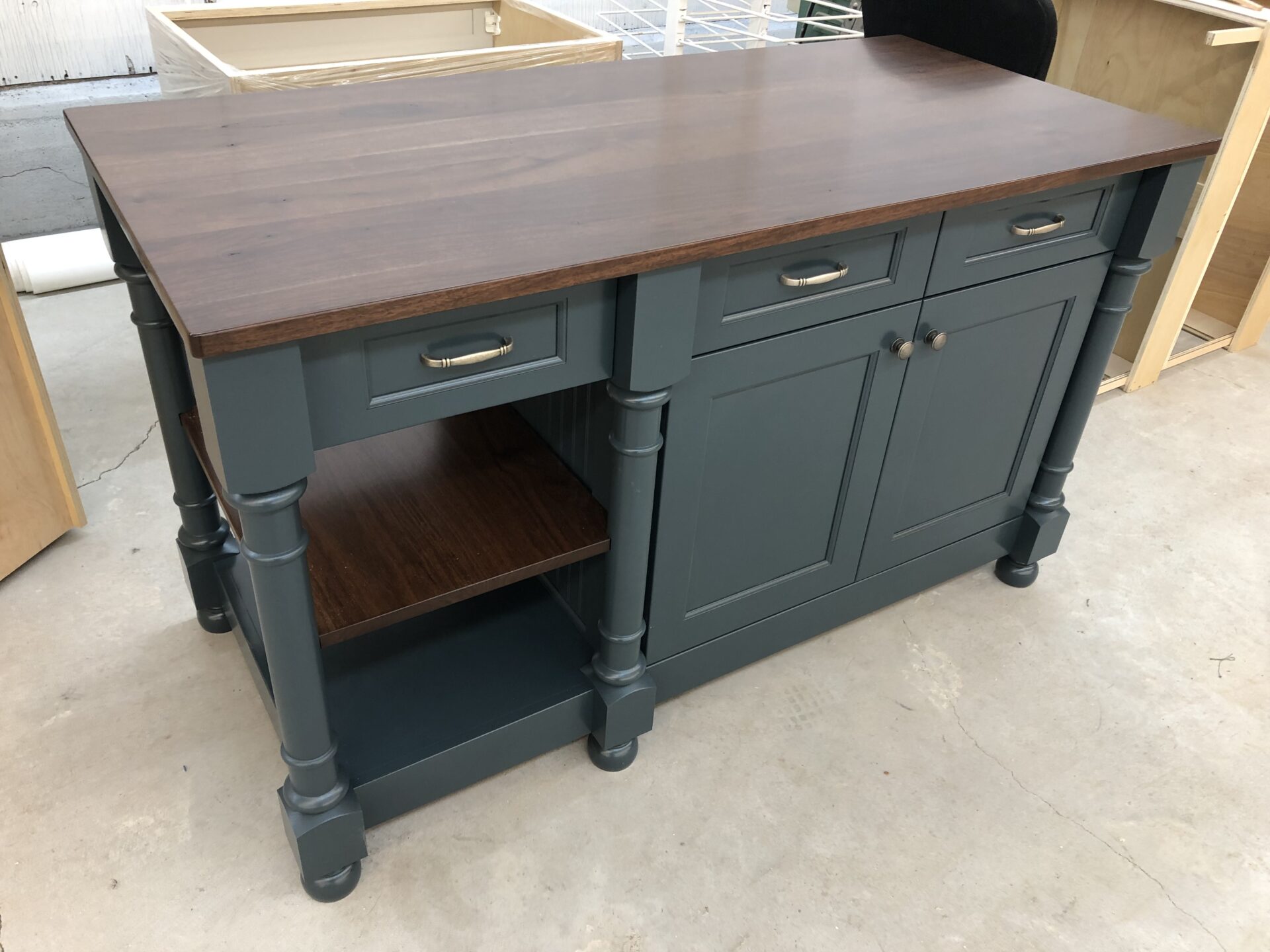 a dark-colored cabinet with a solid wood surface top